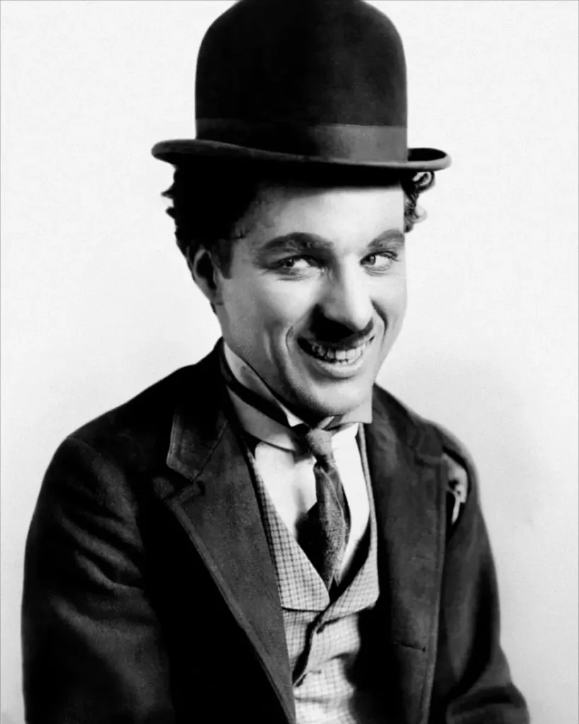 Portrait of Charlie Chaplin in his stage character’s costume — the Tramp — wearing a bowler hat.