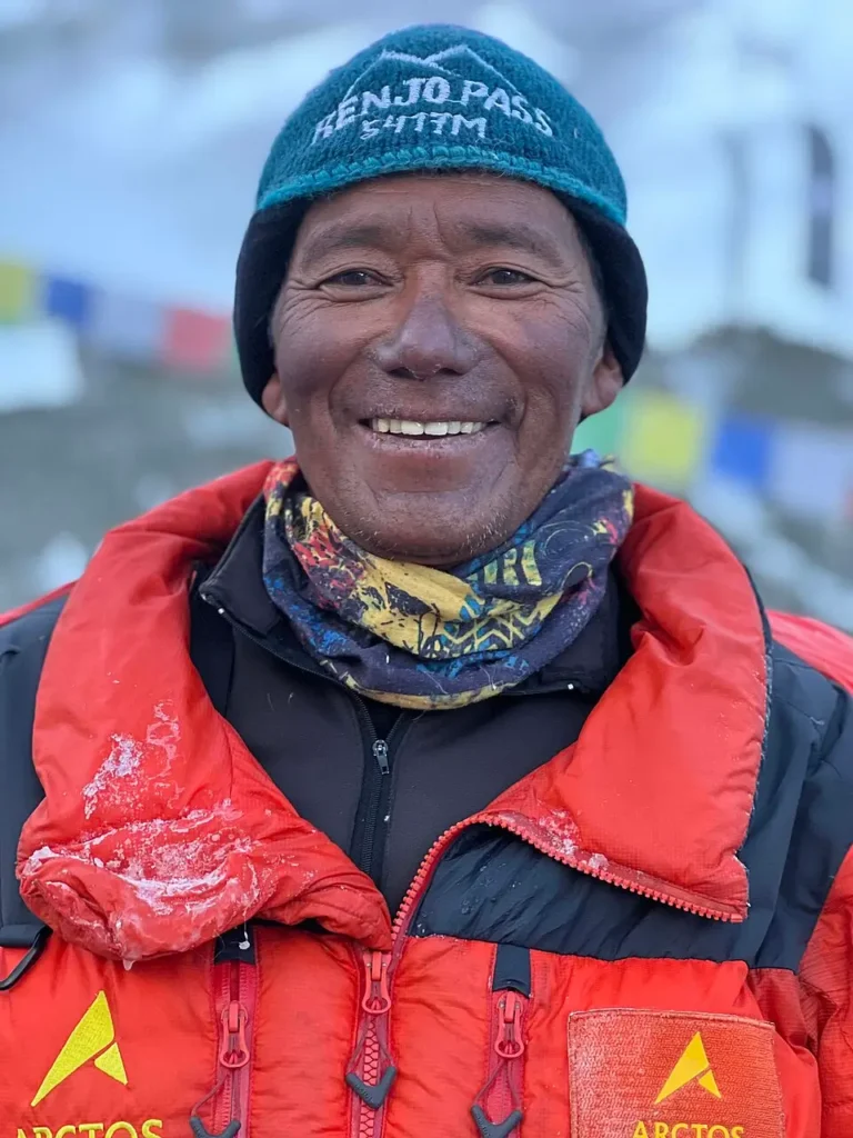 A Sherpa climber on Mount Everest during a high-altitude expedition, carrying equipment and preparing for the ascent.