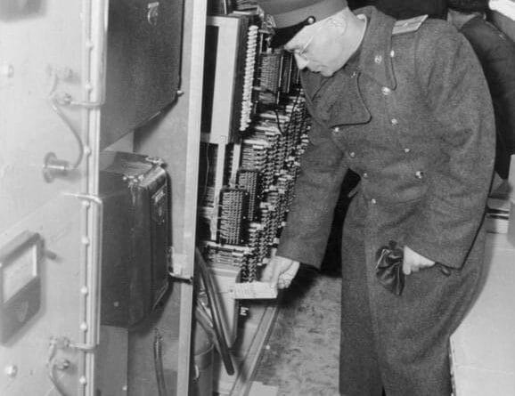 A Soviet officer examines a wiretapping device discovered inside the Operation Gold tunnel in 1956.